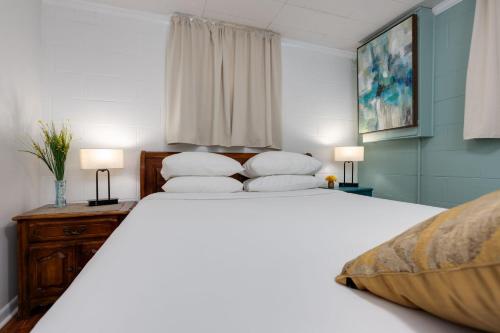 a bedroom with a large white bed with two pillows at Noteworthy Near Opryland in Nashville