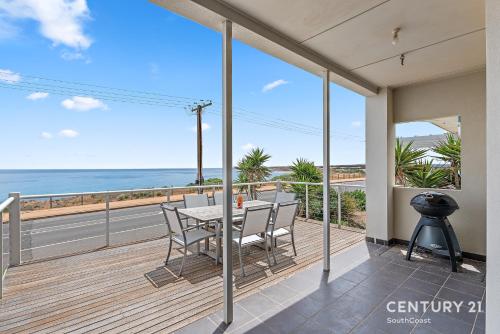 a dining room with a view of the ocean at Percival Point - Port Willunga - C21 SouthCoast Holidays in Port Willunga