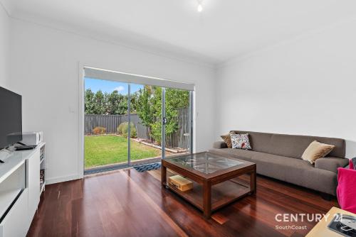 a living room with a couch and a table at Percival Point - Port Willunga - C21 SouthCoast Holidays in Port Willunga