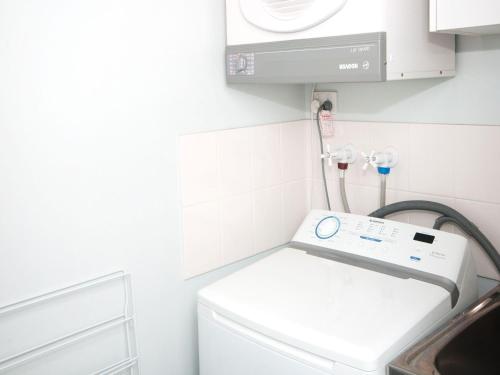 a laundry room with a washing machine and a sink at Nautilus 5 in Hawks Nest