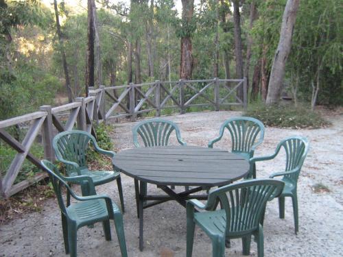 a wooden table and four chairs around a wooden table at Lavenderpatch in Mundaring