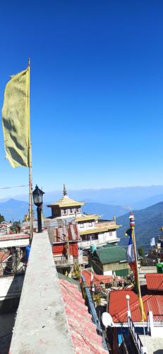a view of a city with a flag on a building at B&B Homestay in Darjeeling