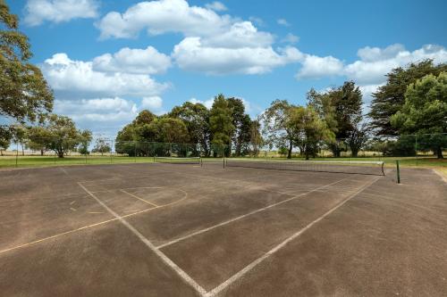 an empty tennis court with trees in the background at Club Wyndham Ballarat, Trademark Collection by Wyndham in Ballarat