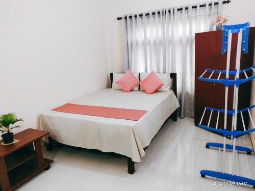 a bedroom with a bed and two blue chairs at Victory's Residence, Mannar in Mannar