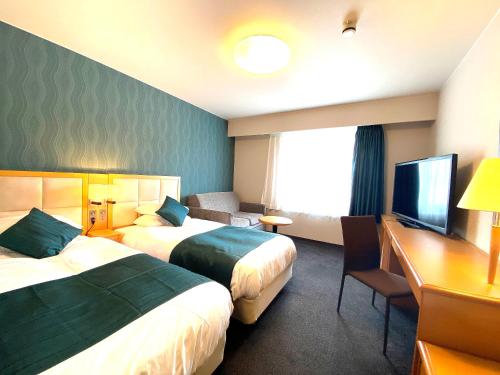 Postel nebo postele na pokoji v ubytování Hotel Sunroute Hikone