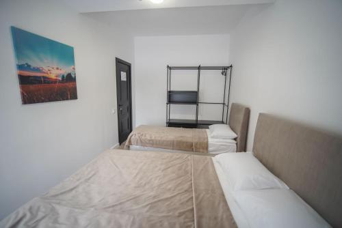 a room with two beds and a picture on the wall at Sulu Hostel in Astana