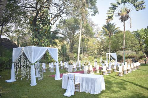 a group of tables and chairs in the grass at Safari Park Hotel in Nairobi