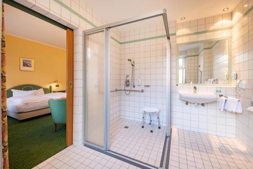 a bathroom with a shower and a sink at Hotel Herzog Georg in Bad Liebenstein