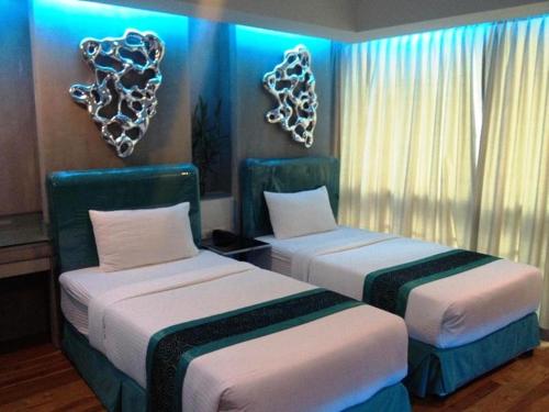 Katil atau katil-katil dalam bilik di Blutique Hotel