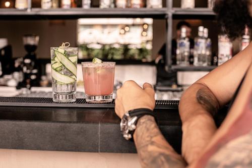 a person with a tattoo on their leg standing at a bar at Sunny Beach Club - Adults Only #YouthfulVibes in Sunny Beach