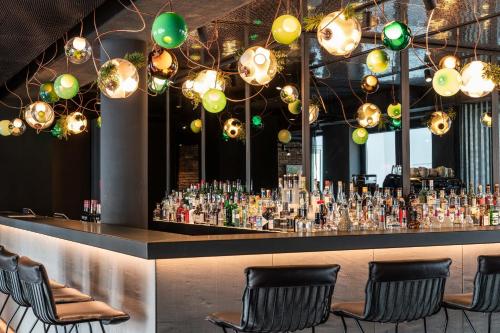 a bar with a lot of drinks and lights at Motel One Berlin Mitte in Berlin