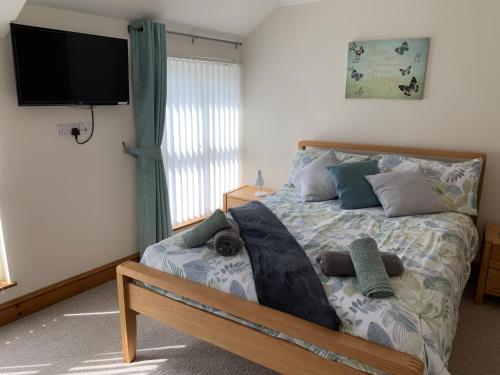 a bedroom with a bed with a dog laying on it at Waters Edge in Penclawdd
