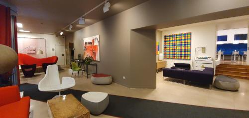 a large living room with a couch and chairs at Hotel Colombia in Trieste
