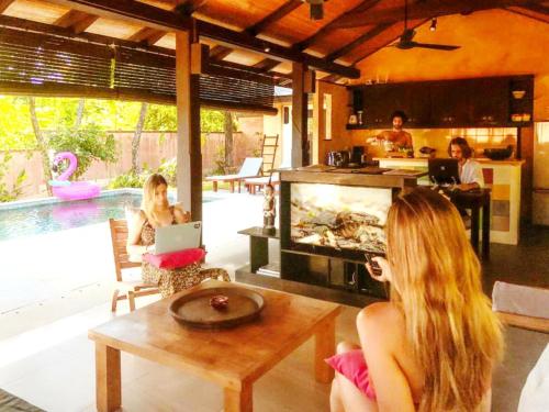 a group of people sitting in a living room with a tv at Alanta Pool Villa in Ko Lanta