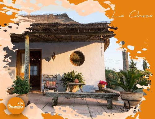 a house with a bench in front of it at La Volandera in Jerez de la Frontera