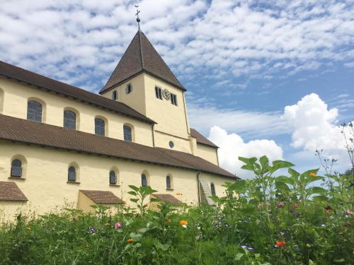 a building with a clock tower on top of it at Haus Münsterblick in Reichenau
