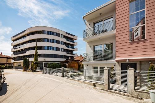 aartment building with a pink and white building at Villa Misija in Ohrid