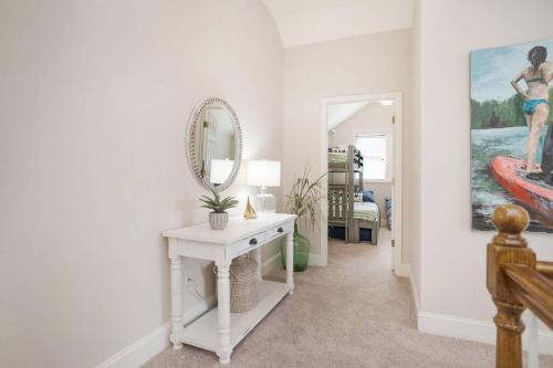 a hallway with a white table and a mirror at Fairway to Heaven in Fripp Island
