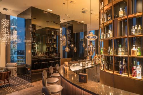 a bar in a restaurant with a view of the city at Motel One Berlin-Upper West in Berlin