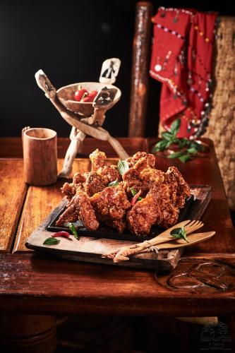 a plate of fried food on a table with chopsticks at Safari Park Hotel in Nairobi