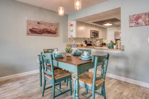 a kitchen and dining room with a table and chairs at Driftwood Escape in Saint Augustine Beach