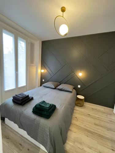 - une chambre avec un grand lit et 2 serviettes dans l'établissement Appartement cosy proche RER et centre ville, au Plessis-Robinson