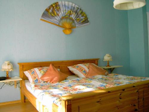 a bedroom with a bed with a fan on the wall at Haus Proksch in Marktschellenberg