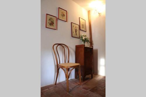 a chair sitting in a room with a wall at Antiche Fonti in Bibbona