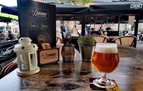 a glass of beer sitting on top of a table at BijHillen in bed in Winterswijk