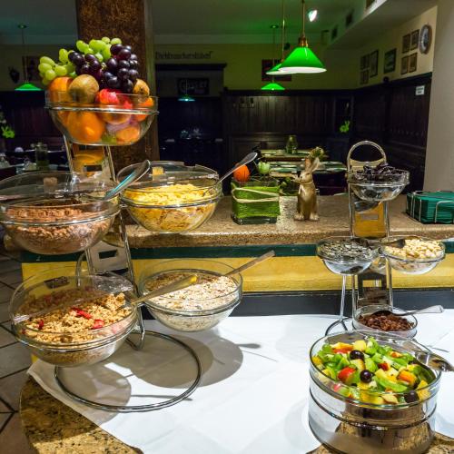 a buffet with bowls of food on a counter at Hotel Gösser Bräu in Wels