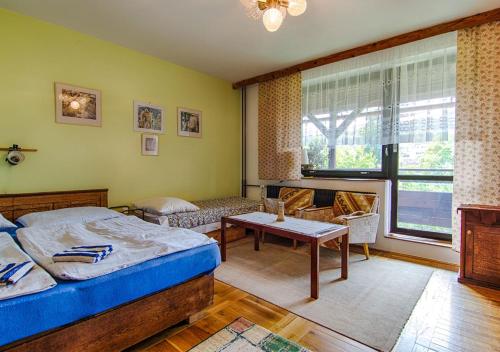Postel nebo postele na pokoji v ubytování Holiday House Rokytnice