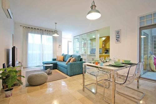 a living room with a blue couch and a table at Believe in Dream Apart. Contemporâneo com Piscina in Tavira