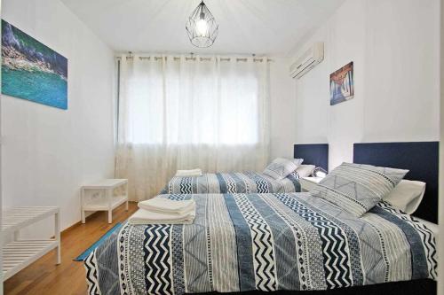 a bedroom with two beds and a window at Believe in Dream Apart Contemporâneo com Piscina in Tavira