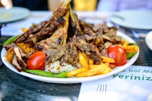 a plate of food with french fries and meat at Naturkoy Sapanca in Sakarya