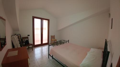 En eller flere senge i et værelse på Appartamento Tra Mare E Lago
