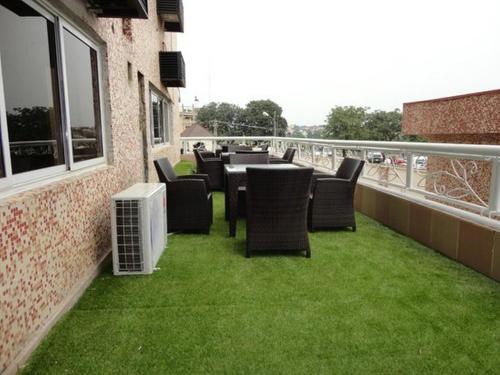 a patio with chairs and a table on a balcony at Grand Ibro Hotel - Standard in Jabi