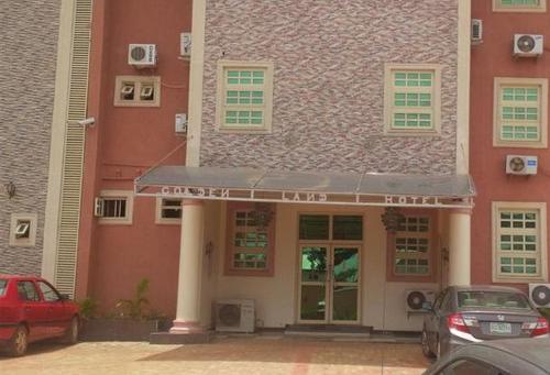 a building with cars parked in front of it at Goldenland Hotels - Executive in Asaba