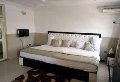سرير أو أسرّة في غرفة في Room in Lodge - Goldenland Hotels Limited
