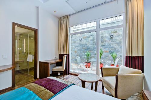 a hotel room with a bed and a balcony at La Sagrita in New Delhi
