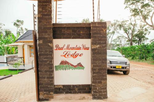 a sign for a mountain lodge lodge at Dual Mountain View Lodge in Moshi