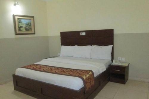 a bedroom with a large bed in a hotel room at Joy House Hotel - Solace in Abuja
