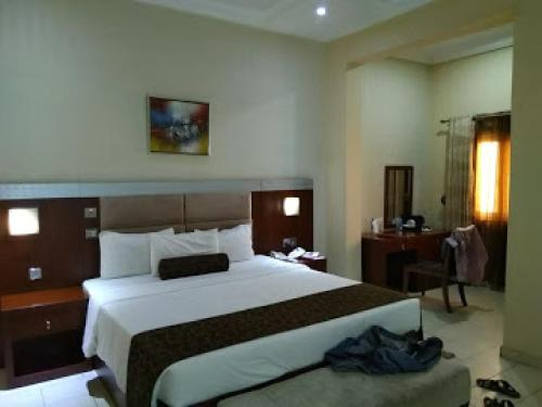 a hotel room with a large bed and a desk at Room in Lodge - Nippon Grand Hotels in Jabi