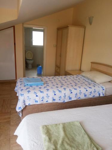 a bedroom with two beds and a bathroom at Dove Apart Hotel in Fethiye