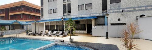 a swimming pool in front of a building at Owu Crown Hotel - Regular in Ibadan