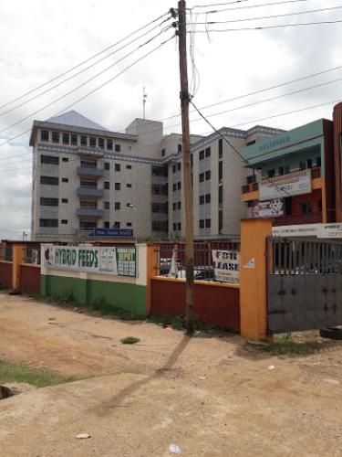 a large building in front of a building at Owu Crown Hotel - Regular in Ibadan