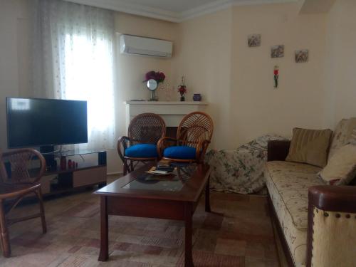 a living room with a couch and a table at Dove Apart Hotel in Fethiye