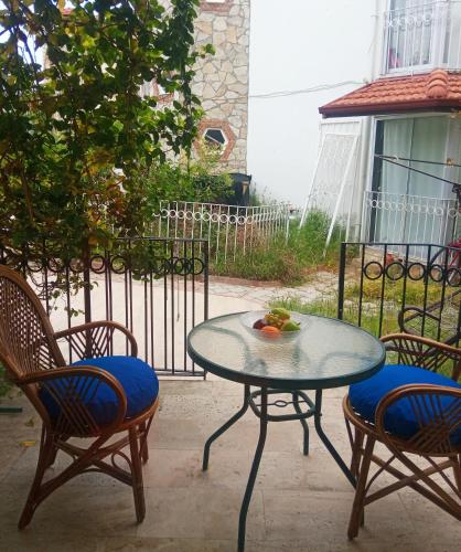 a table and chairs with a bowl of fruit on it at Dove Apart Hotel in Fethiye