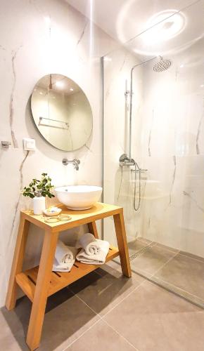 a bathroom with a sink and a shower at Mediterraneo Suite Home in Rethymno