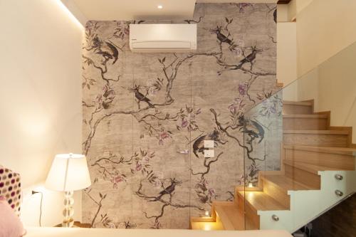 a staircase with a wall mural of flowers at Villa Francesca Relais in Gradara