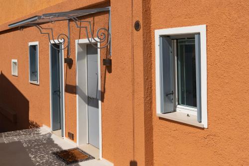 a row of windows on the side of a building at Villa Francesca Relais in Gradara